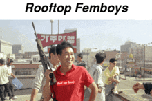 a man in a red shirt that says rooftop femboys on it