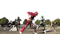 a group of power rangers are standing in a field