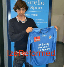 a man is holding a blue shirt that says banca popolare di novara