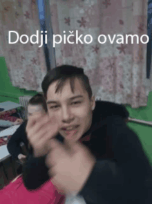 a young man in a classroom with the words dodji picko ovamo on the bottom