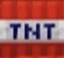 a close up of a tnt logo on a red and white background .