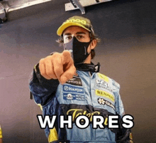 a man wearing a mask and a hat is pointing at the camera with the words whores on the bottom