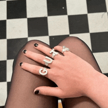 a woman wearing a ring that says guta on her finger