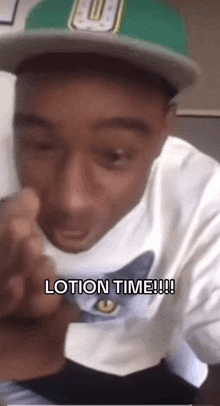 a man wearing a hat and a white shirt says " lotion time "