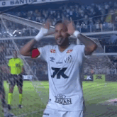 a soccer player wearing a white shirt with the word tavan on the front