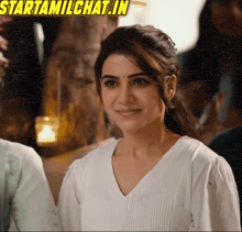 a woman in a white shirt is smiling with the words starttamilchat.in above her
