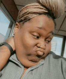 a woman is making a funny face while wearing a headband and a watch .