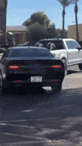 a black dodge challenger with a license plate that says ona 328