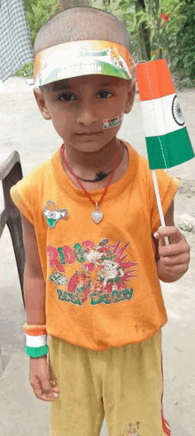 a young boy wearing an orange shirt that says ' rider ' on it