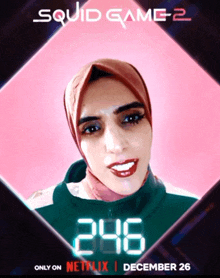 a poster for squid game 2 shows a woman with a hijab on