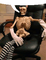 a skeleton is sitting in a chair with a cat ear