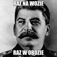 a black and white photo of a man with a mustache and the words `` raz na wozie raz w obrozie '' .