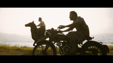 a man riding a motorcycle next to a man on a horse