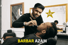 a man getting his beard shaved by a barber with the name barbar azam on the bottom