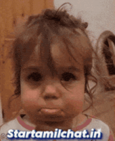 a little girl making a funny face with the words starttamilchat.in written below her