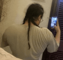 a woman is taking a picture of herself with her cell phone