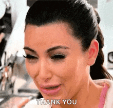 a woman is crying while saying thank you .