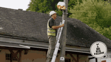 a man standing on a ladder fixing a street light next to a sign that says " a mi kis falunk "