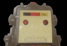 a close up of a toy robot with red lights on it .