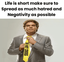 a man in a suit with a yellow tie that says do not cross on it