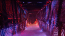 a very long hallway with red and blue lights