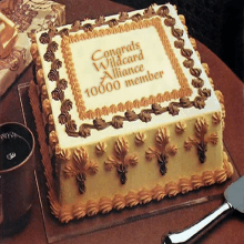 a square cake with congratulations wildcard alliance 10000 member written on it