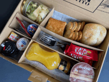 a box filled with a variety of snacks including a kitkat bar