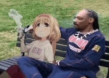 snoop dogg is sitting on a park bench with a picture of a girl on his lap .