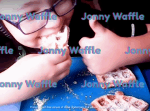 a person is eating a waffle with the name jonny waffle written on it