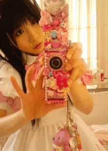 a girl in a white dress is taking a picture of herself in a mirror