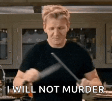 a man in a black shirt is holding a knife in his hand and says `` i will not murder '' .