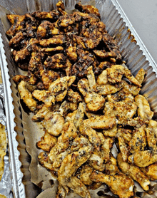 a tray of fried chicken is sitting on a piece of paper