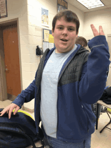 a boy giving a peace sign in front of a poster that says math