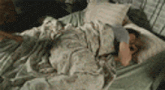 a man is laying in a bed with a dog .