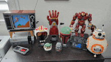 a collection of lego toys including a boba fett helmet and a hulk statue