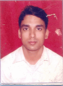 a man in a white shirt stands in front of a red backdrop