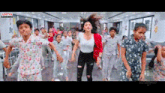 a woman is dancing in front of a group of children in a room .