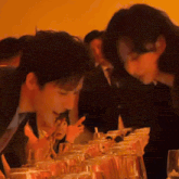 a group of people are sitting at a table with glasses of wine