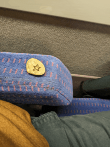 a coin with a star on it sits on a blue cushion