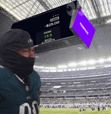 a man wearing a mask stands in front of a scoreboard that says prizepicks on it