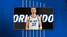 a basketball player with the number 22 on his jersey stands in front of a blue background