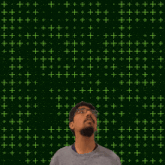a man with glasses looks up at the number 9