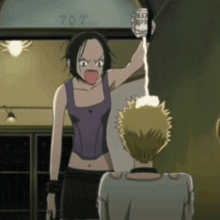 a woman in a purple tank top is yelling at a man in a white shirt