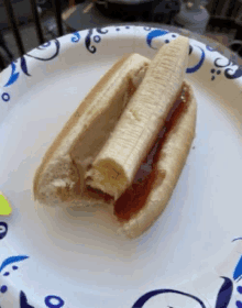 a paper plate with a hot dog with peanut butter and jelly on it