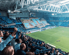 a soccer stadium with a banner that says " a du den stad som fall allt "