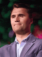 a man wearing a purple suit and a white shirt