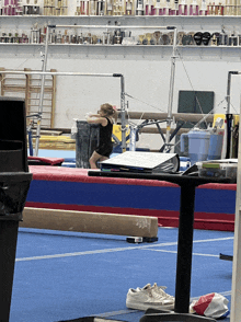 a girl is doing a routine on a balance beam