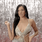 a woman in a dress with a dollar sign necklace on her neck