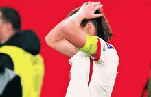 a soccer player wearing a yellow armband that says restart