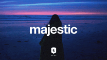 a poster for majestic shows a woman standing on the beach at sunset